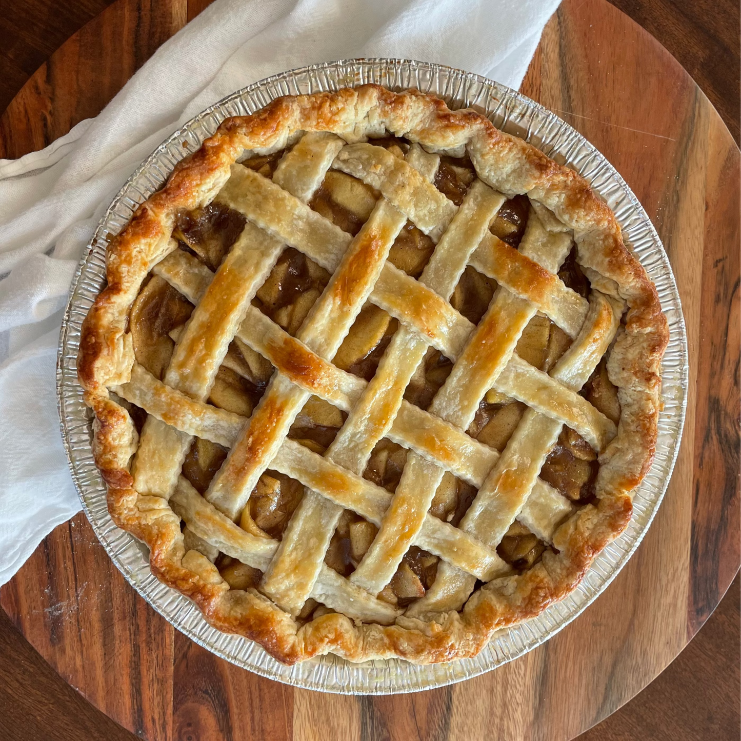 Apple pie with lattice crust on a wooden table