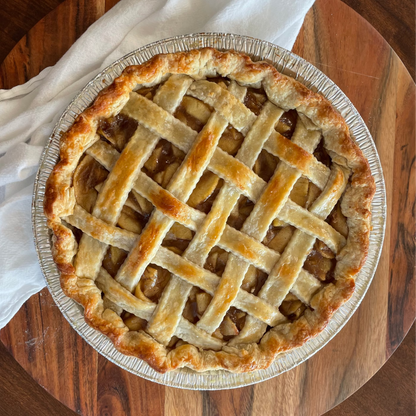 Apple pie with lattice crust on a wooden table