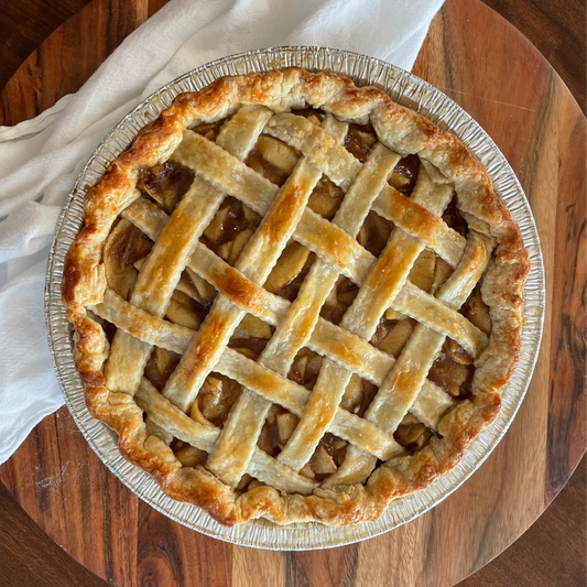 Apple pie with lattice crust on a wooden table